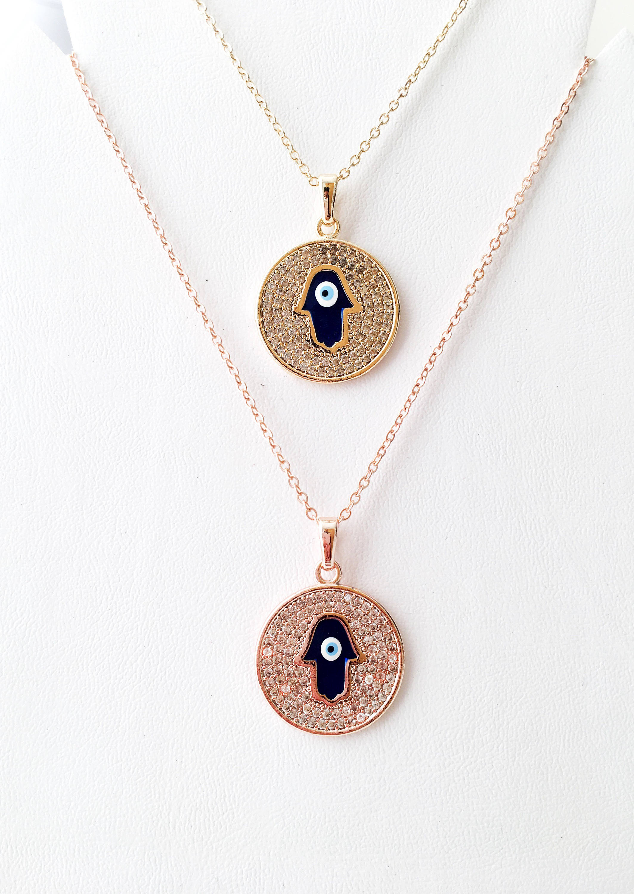 Zircon Evil Eye Necklace featuring a Hamsa Hand charm, available in gold and rose gold, showcasing intricate handmade craftsmanship.