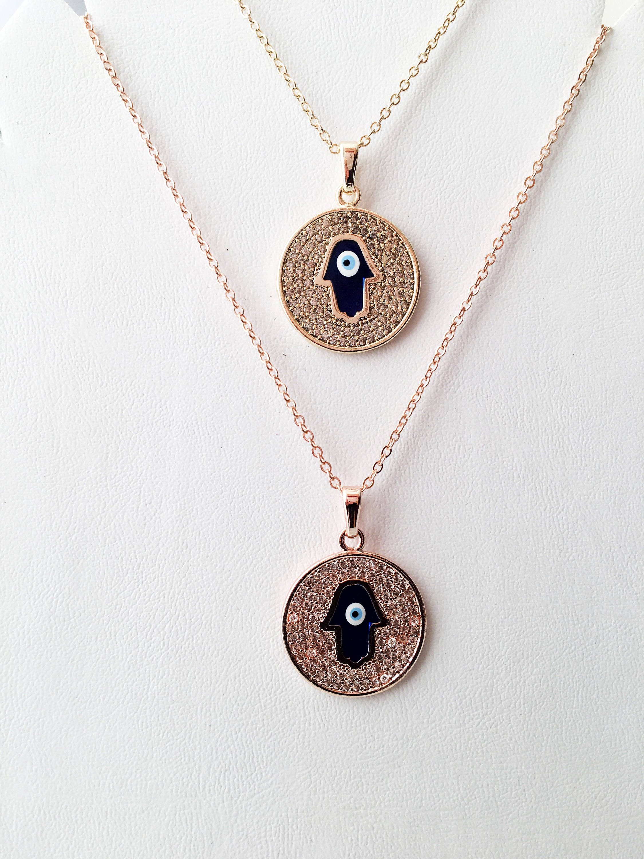 Zircon Evil Eye Necklace featuring a Hamsa Hand charm, available in gold and rose gold, showcasing intricate handmade craftsmanship.