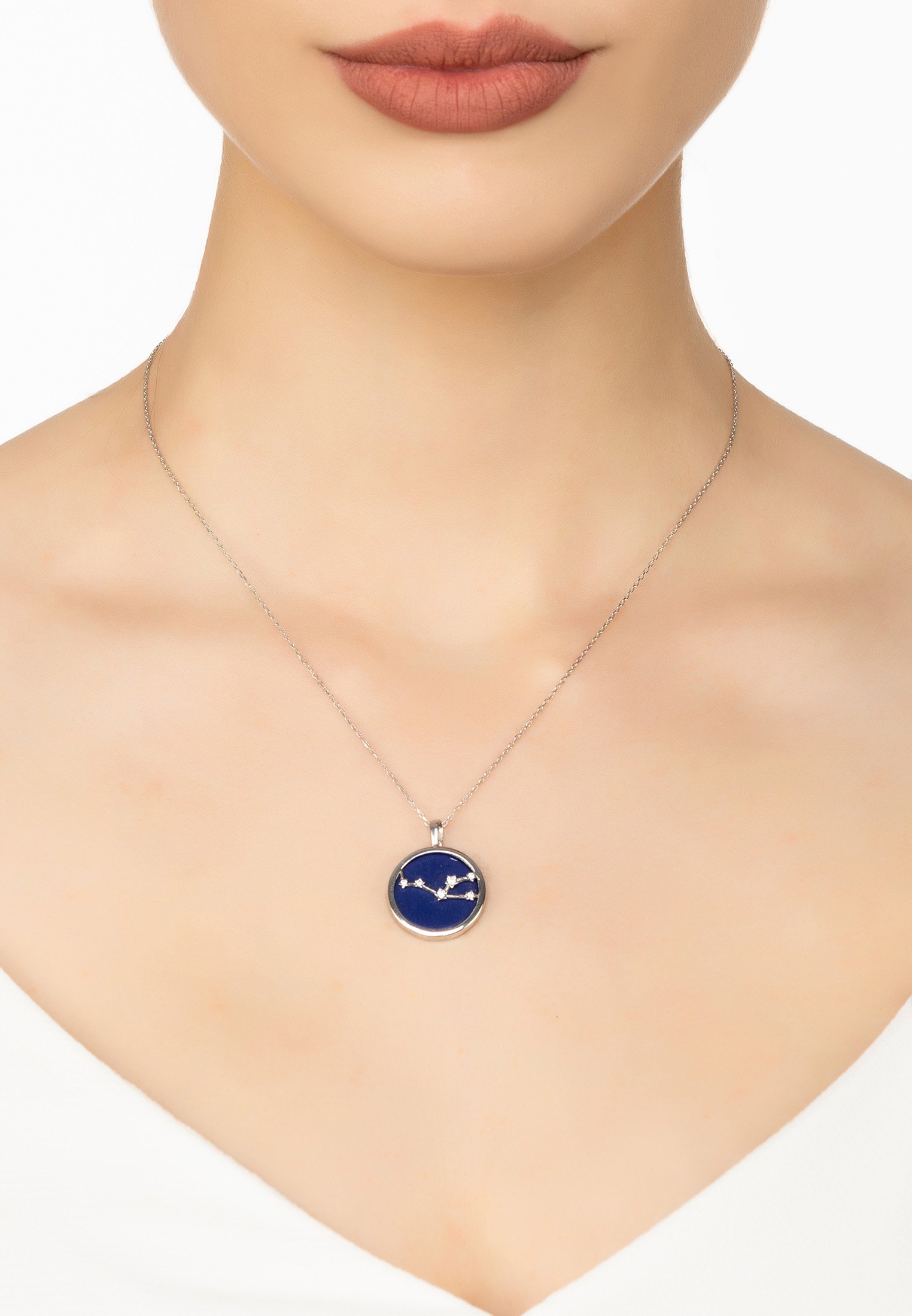 Zodiac Lapis Lazuli Gemstone Star Constellation Pendant Necklace featuring a dark blue lapis lazuli disc with cubic zirconia stars and sterling silver chain.