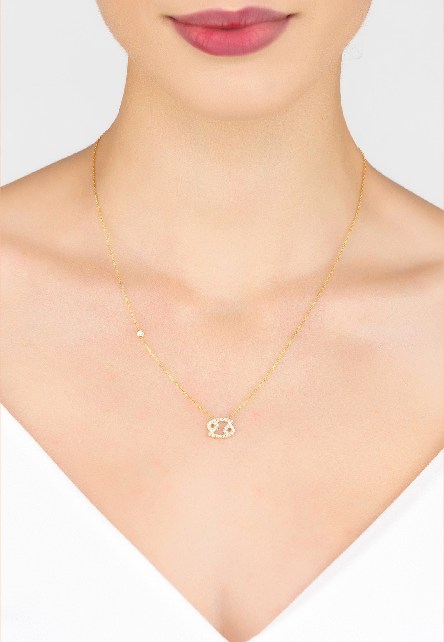 Gold Cancer Zodiac Star Sign Pendant Necklace with white zircons on a delicate chain.