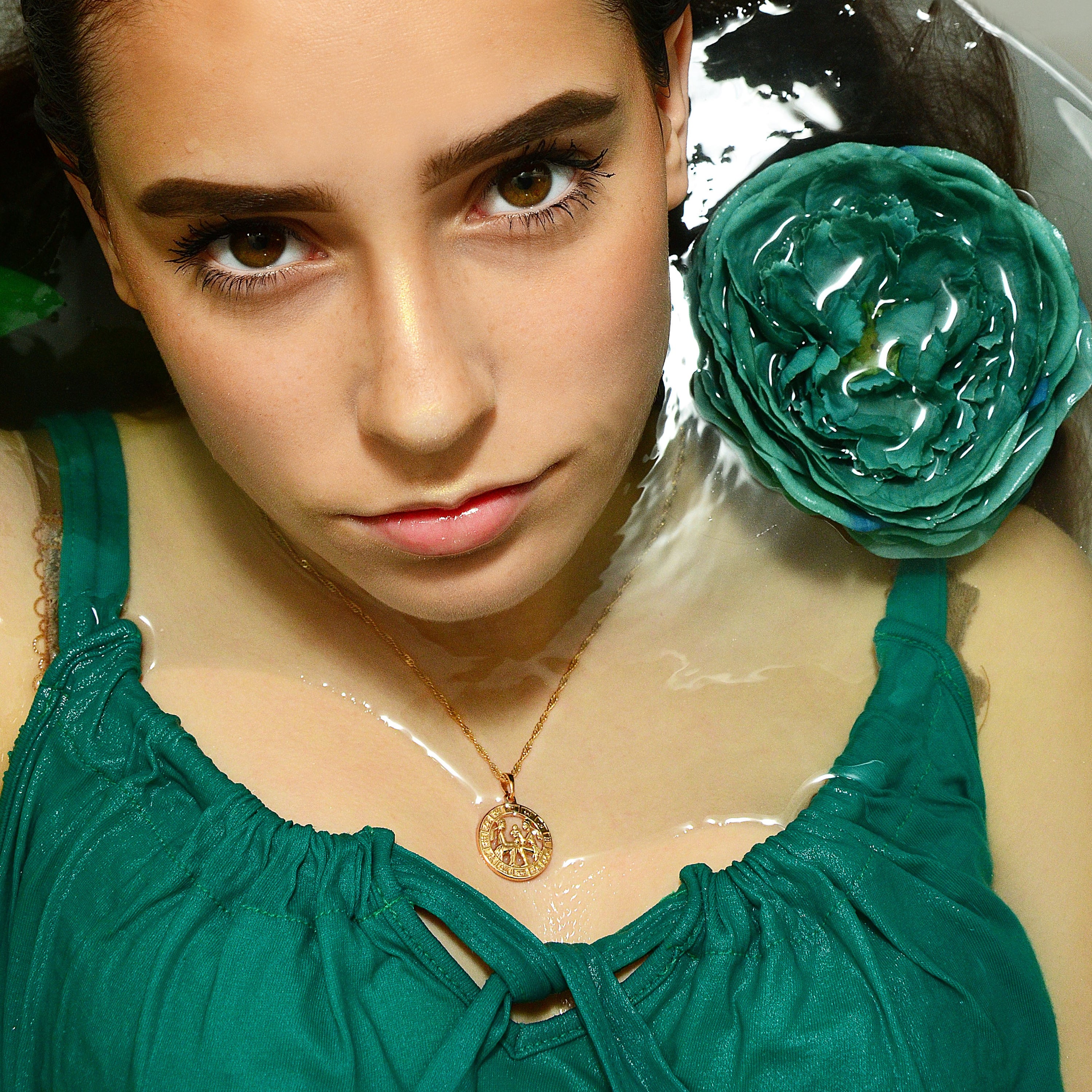 Zodiac Symbol Coin Necklace featuring a gold plated stainless steel pendant with astrological symbols, displayed on a delicate chain.