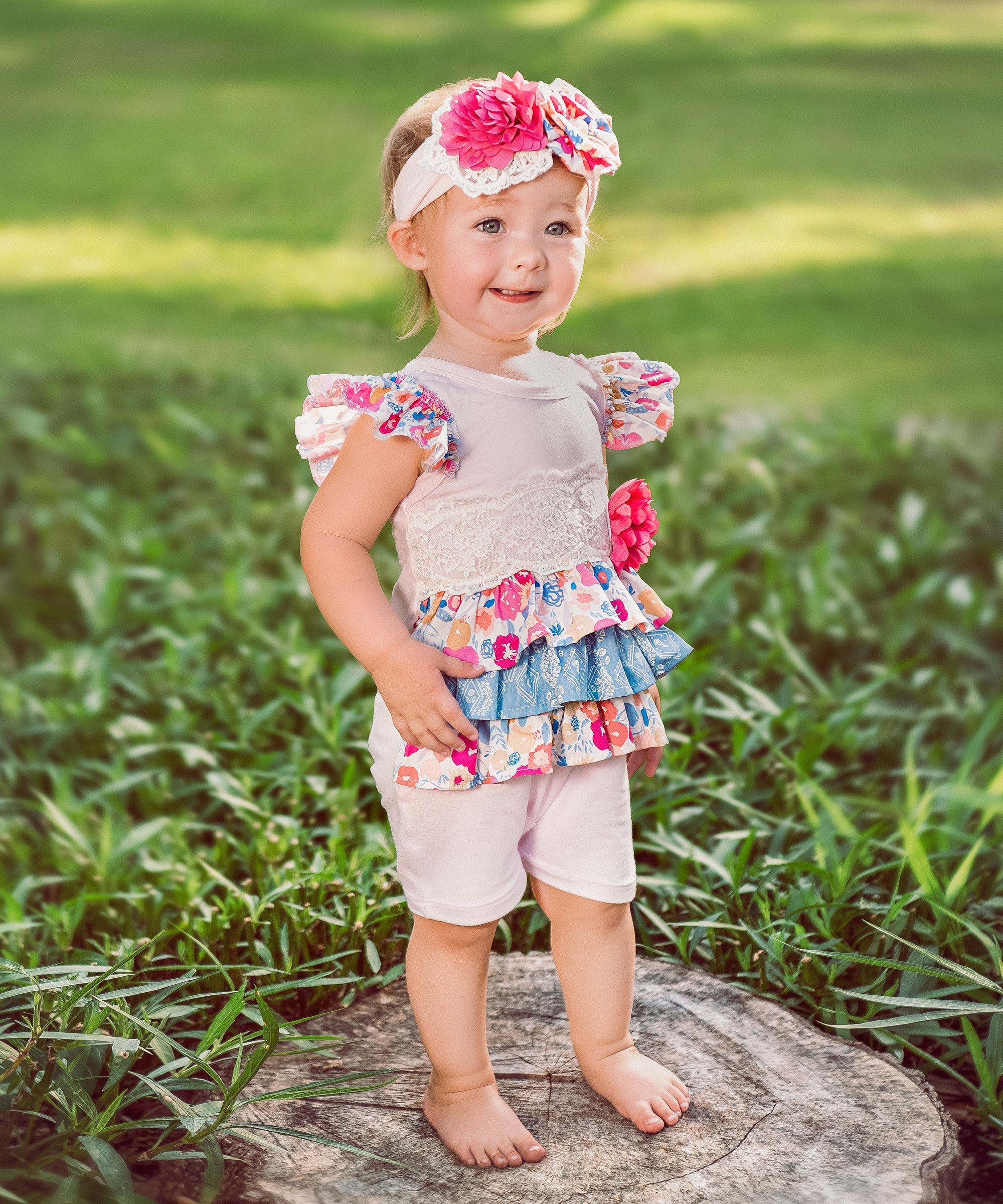 A cute Bandera Blossom Baby Romper featuring a floral design, perfect for infants and toddlers.