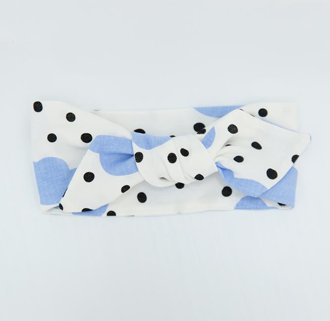 A soft blue clouds headband made from 100% GOTS organic cotton, designed for babies with an adjustable fit.
