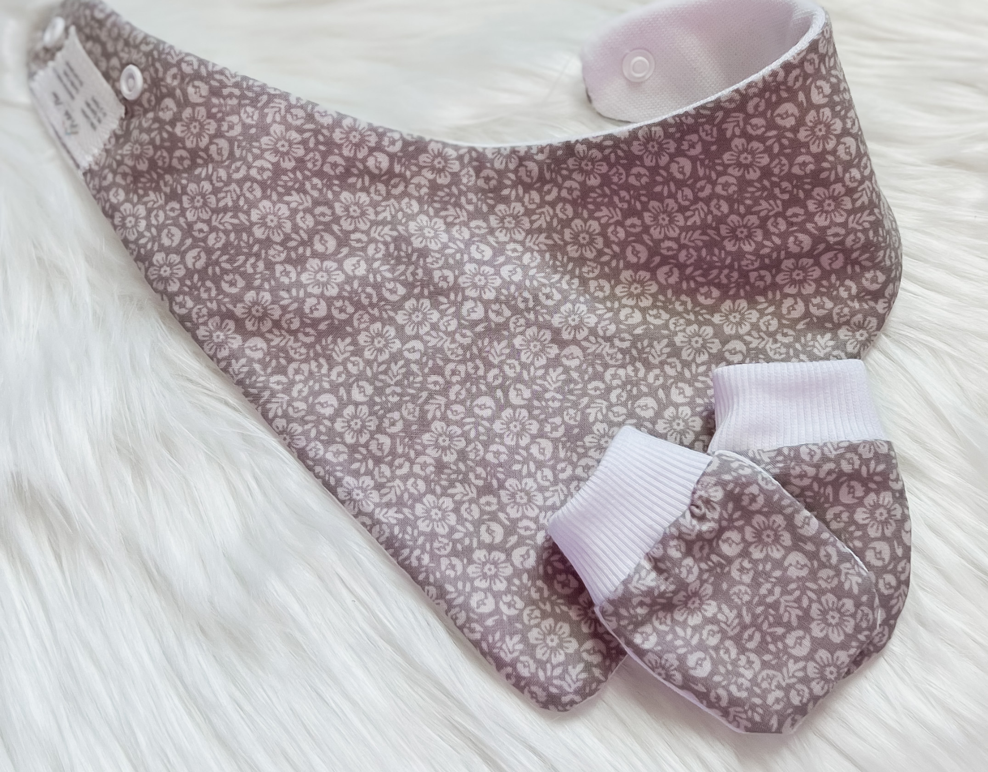 Gray floral bandana bib paired with no scratch hand mittens, designed for babies aged 3-24 months, showcasing a stylish and functional accessory set.