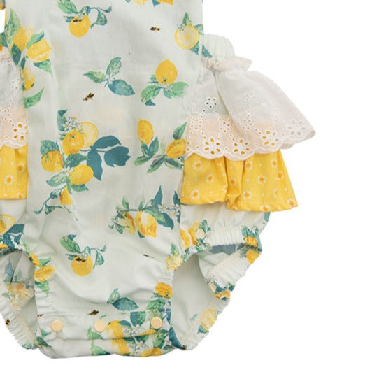 Lucy’s Lemonade Sunsuit featuring a vibrant lemon print, designed for children, perfect for summer outings.