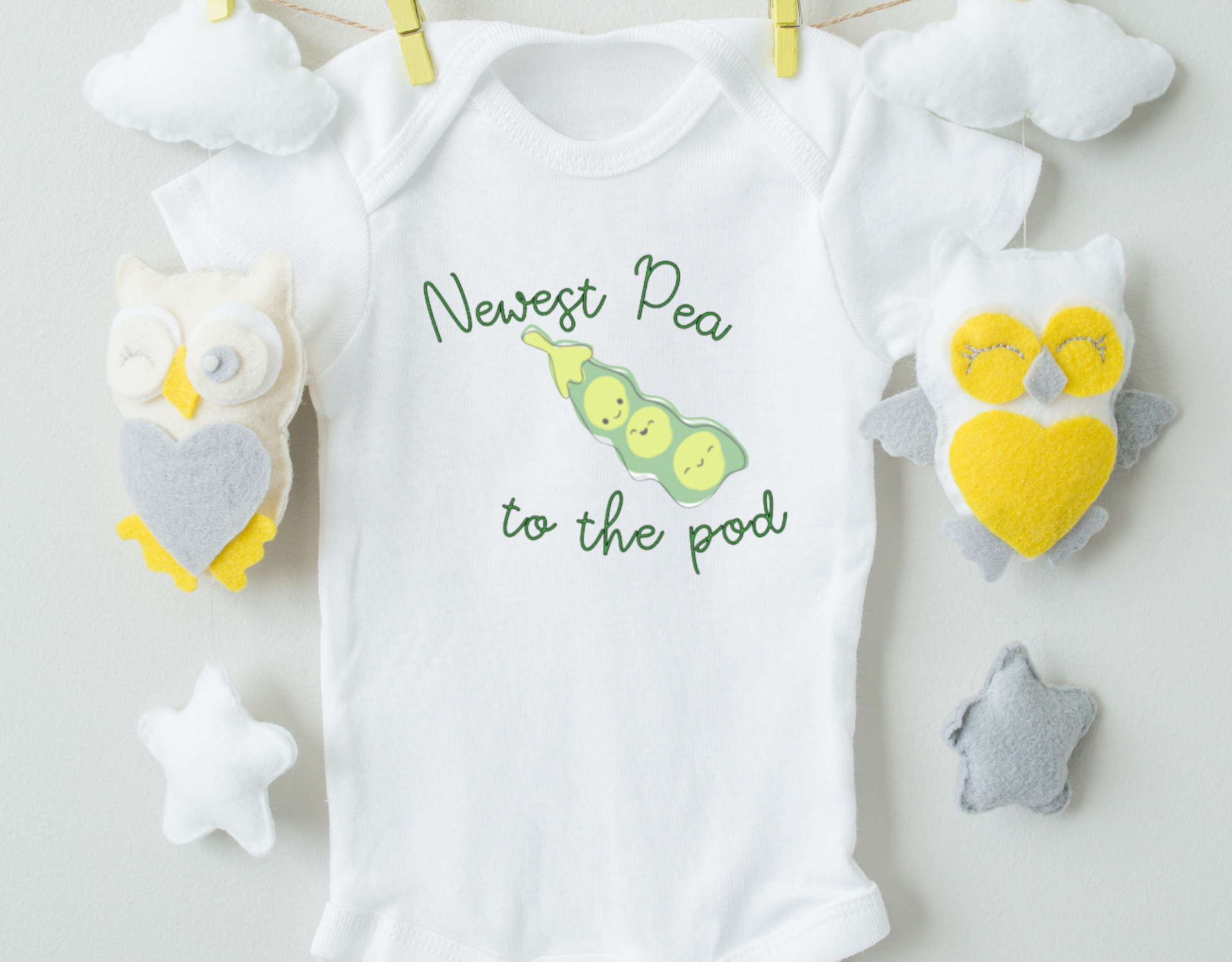 Newest Pea To The Pod Bodysuit in 100% cotton with heat transfer vinyl design, featuring an expandable neckline and snap closure.