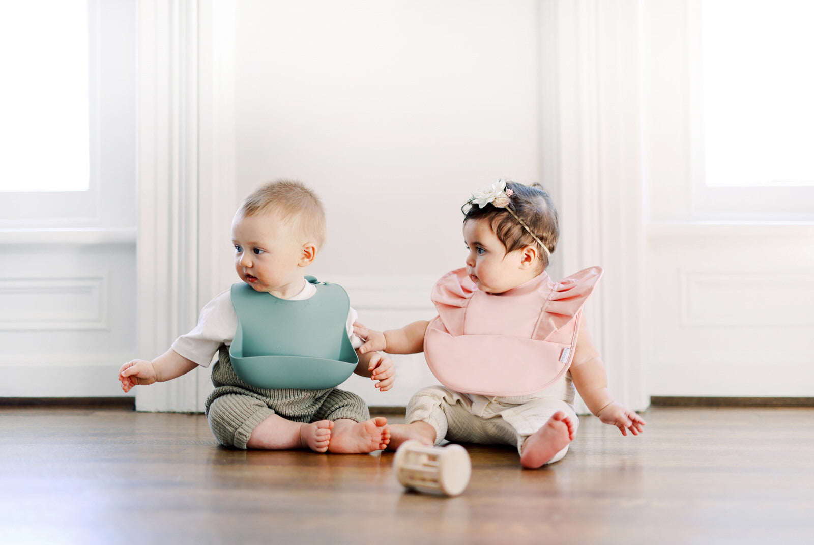 Pink Blush Ruffle Angel Bib featuring a soft, flexible design with a ruffle edge and a built-in pocket for spills.