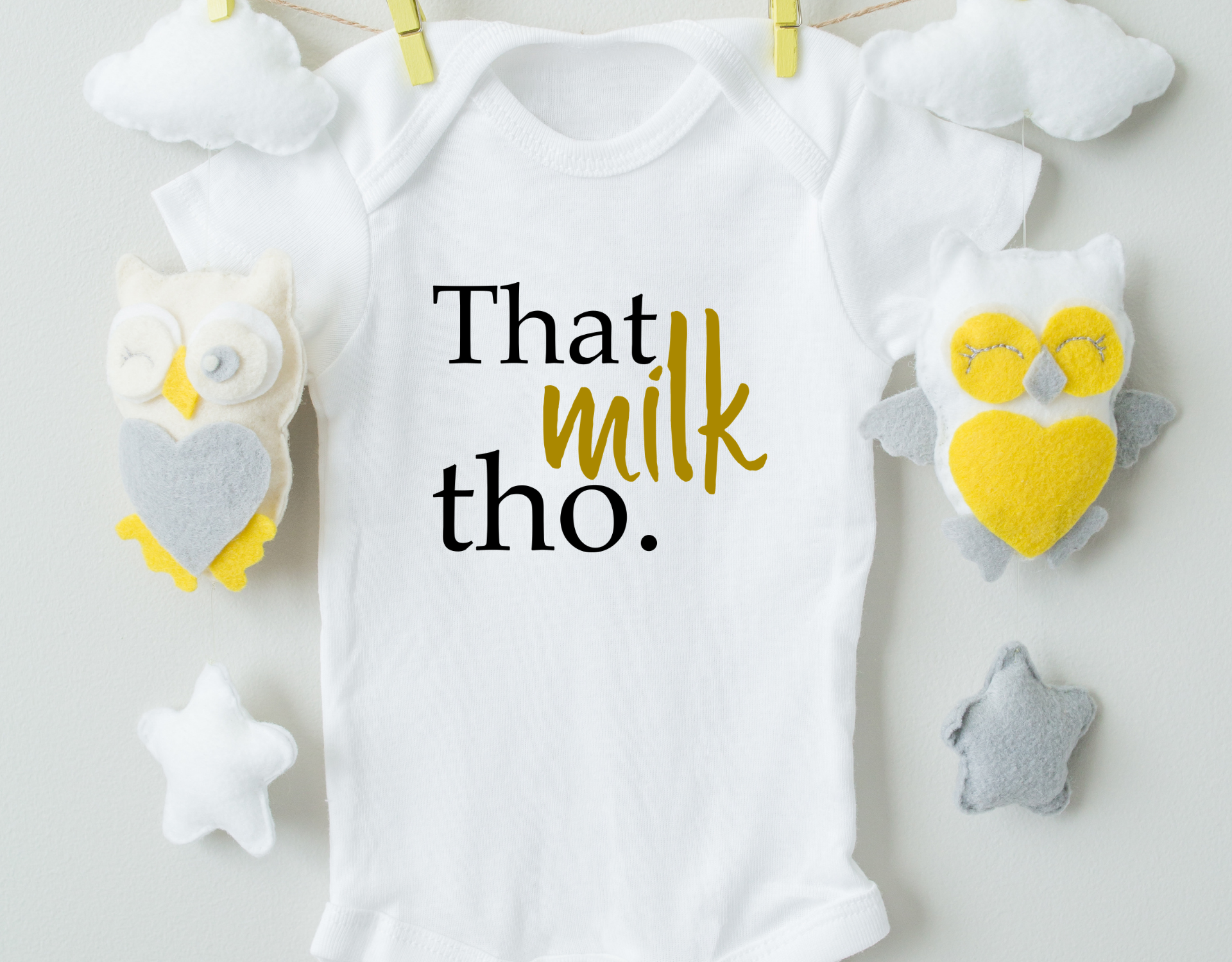 That Milk Tho Cotton Baby Bodysuit in white with a playful design, featuring an expandable neckline and snap closure for easy dressing.
