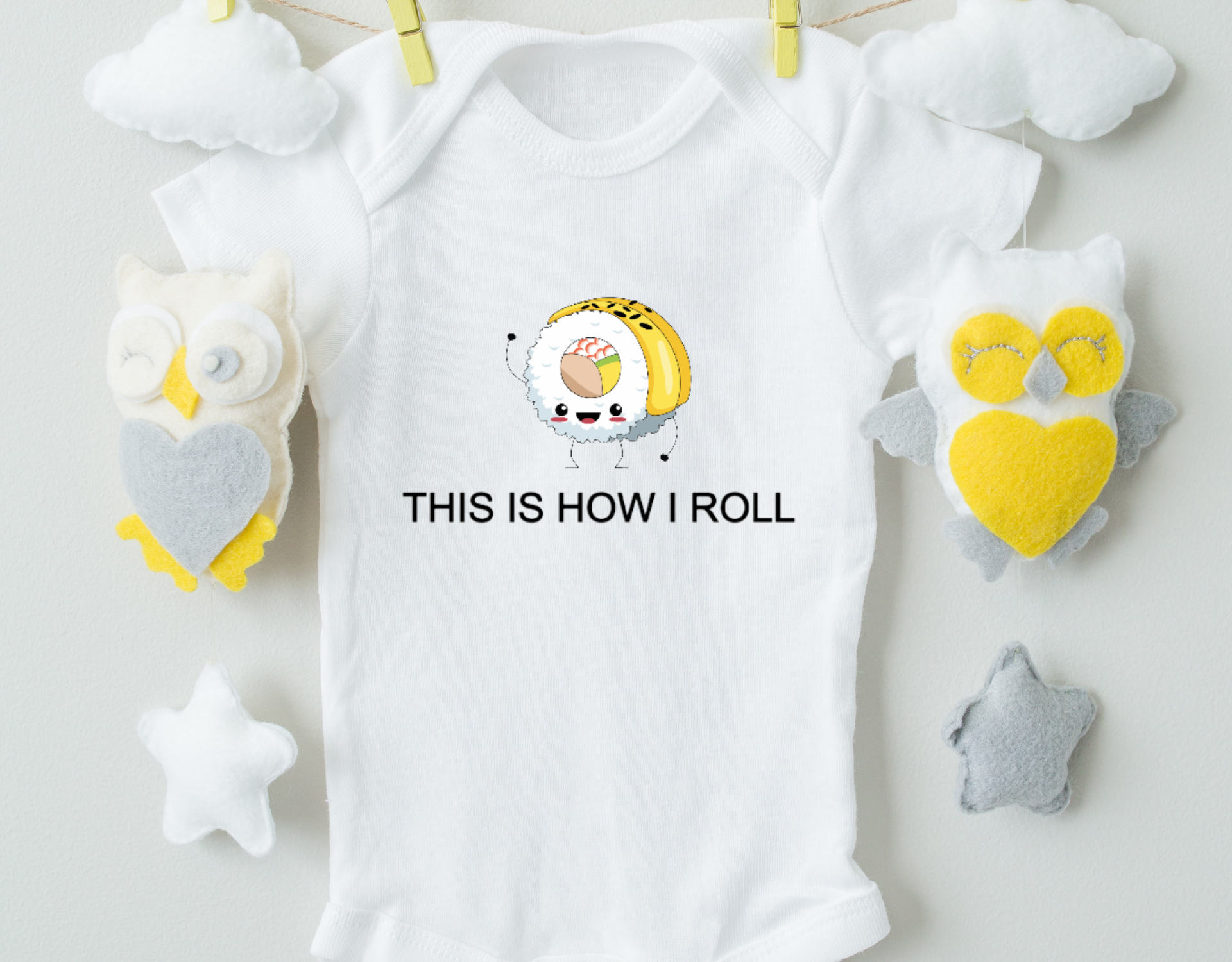 This Is How I Roll Bodysuit featuring a fun design, made from 100% cotton with an expandable neckline and snap closure.