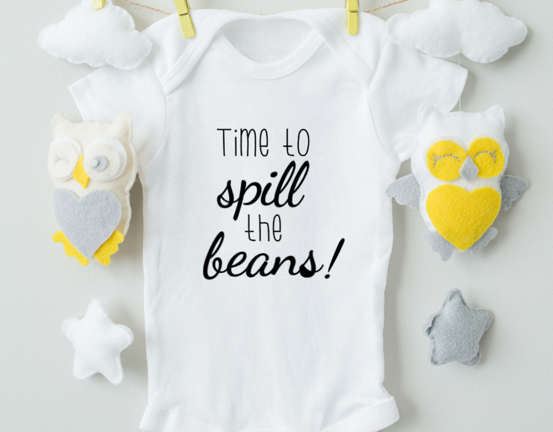 Time To Spill The Beans Cotton Baby Bodysuit in white with a playful design, featuring an expandable neckline and snap closure for easy dressing.