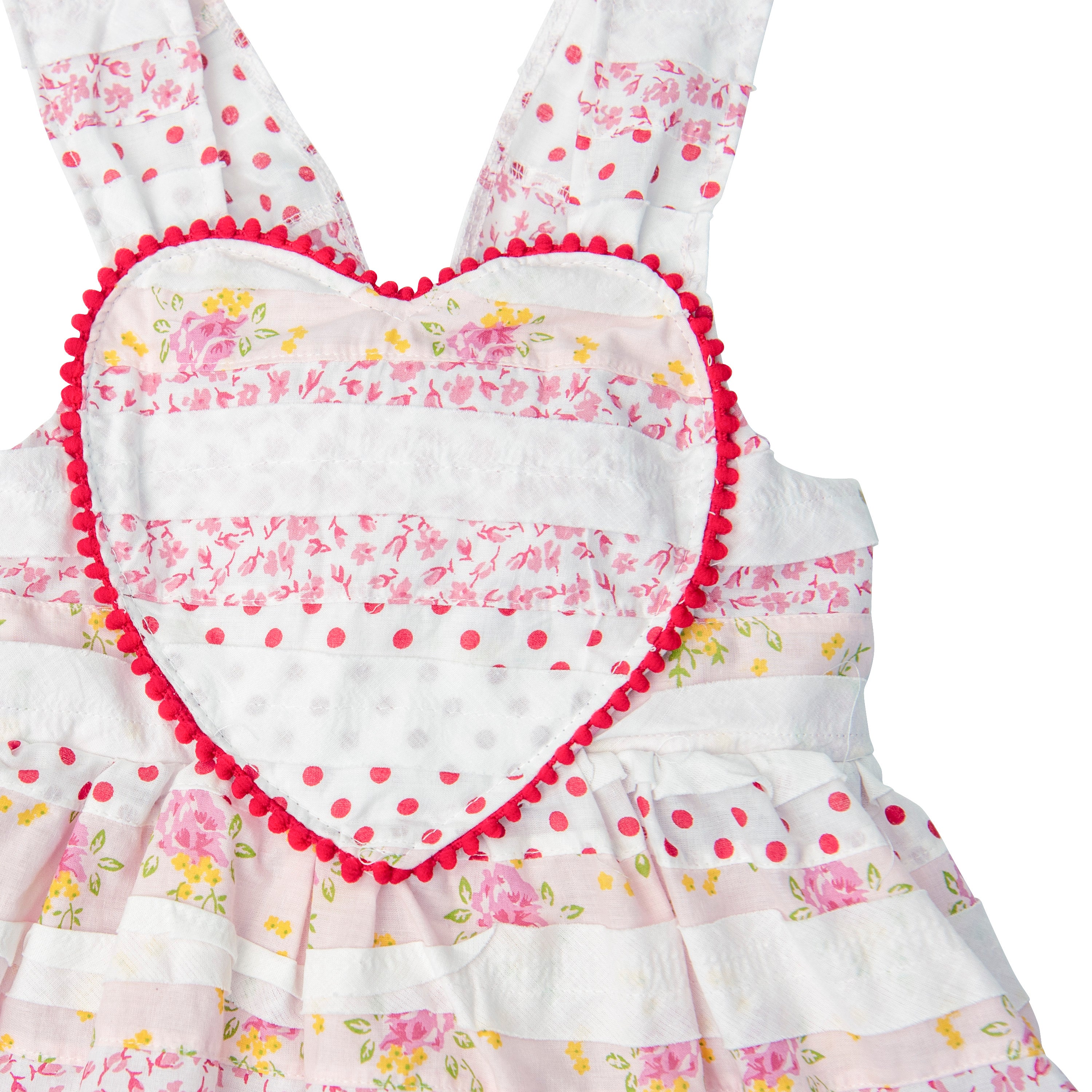 A vibrant Valentine's Sweetheart Dress featuring a Heart Bib Bodice, designed for little girls, in pink and red colors with ruffles.