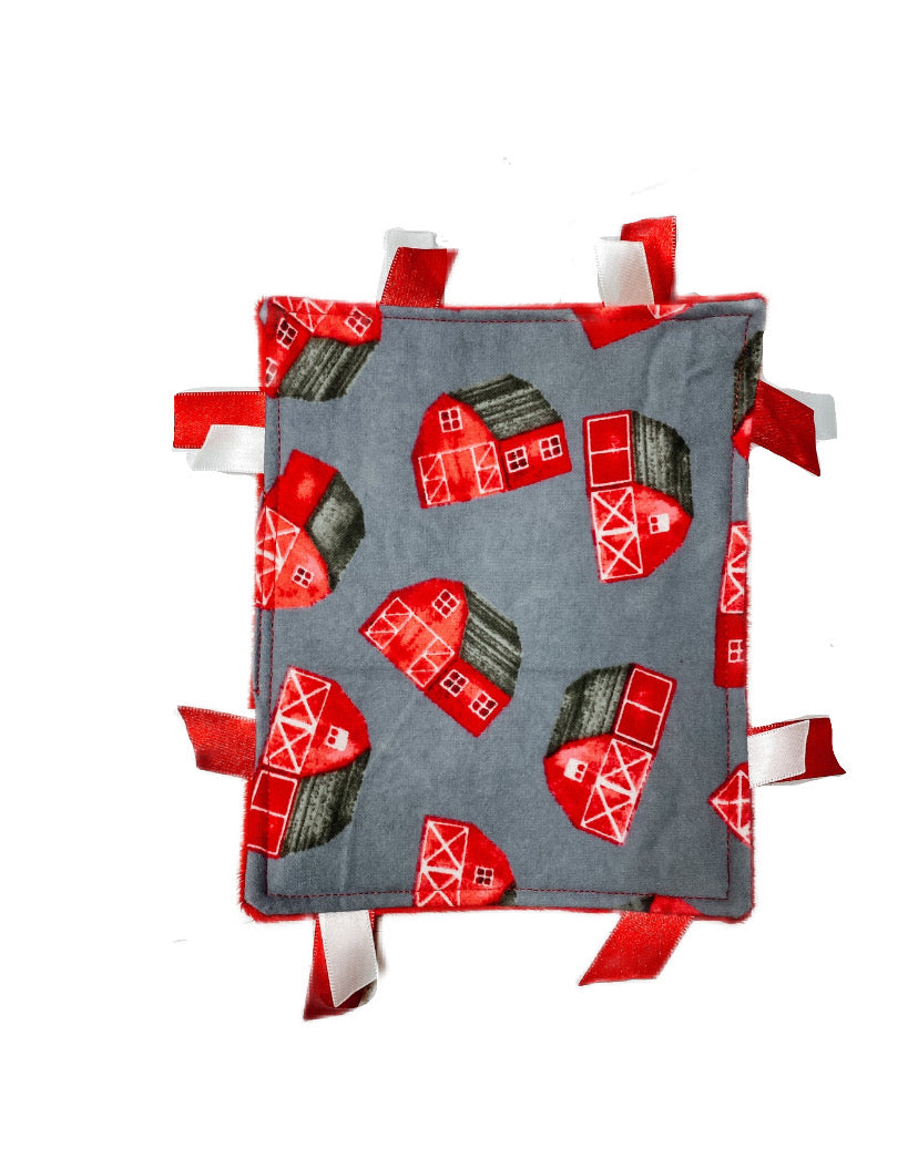 Barn crinkle sensory toy for baby with red and white ribbons, featuring a barn flannel print and smooth red minky backing.