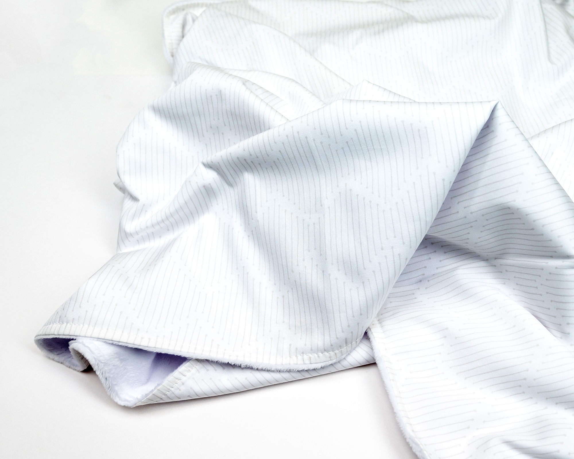 Bowties & Bobby Socks Baby Blanket featuring ivory color with beige penciled line and X pattern, made from 100% premium cotton with minky backing.