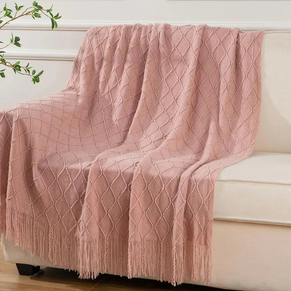 A beautifully woven Decorative Fringe Throw Blanket featuring a geometric design in vibrant colors, perfect for adding warmth and style to any home decor.