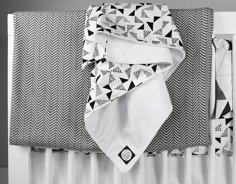 Felix & Marti Baby Blanket featuring a modern Multi-Triangle design in soft cotton and plush minky fabric, perfect for nurseries.
