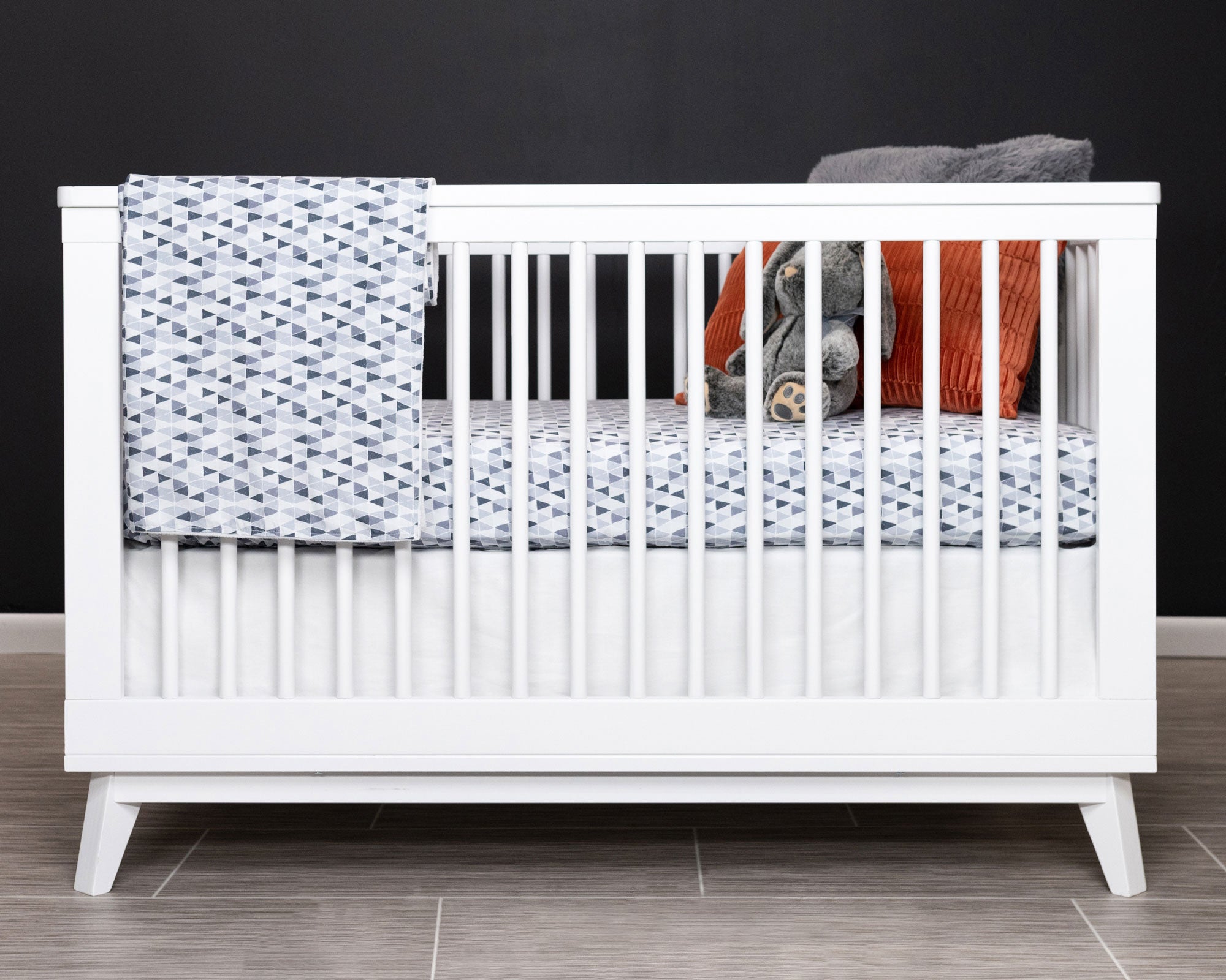 Gray Banners Marching Classic Crib Bedding Set featuring modern triangles in gray, includes crib skirt, fitted sheet, and baby blanket.