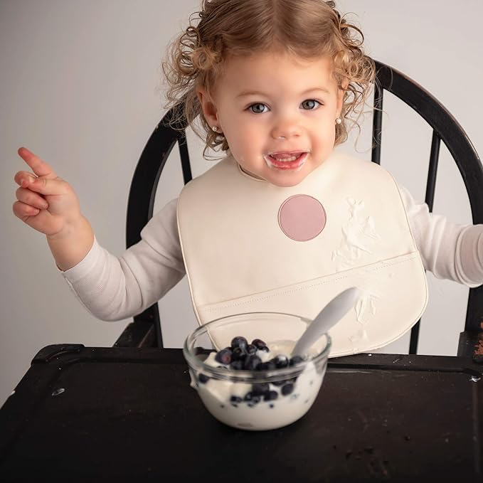 Set of premium vegan leather bibs for infants and toddlers, featuring adjustable snaps and a large pocket for easy cleaning.