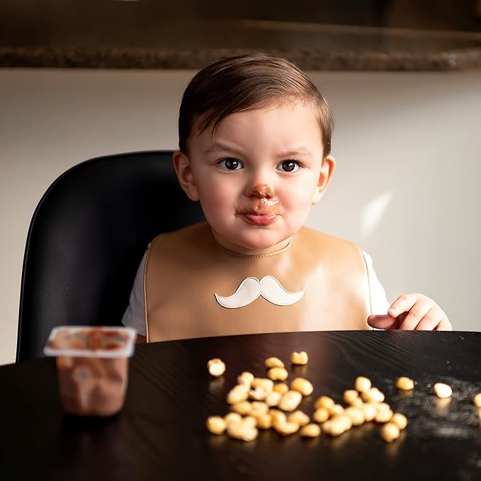 Set of premium vegan leather bibs for infants and toddlers, featuring adjustable snaps and a large pocket for easy cleaning.