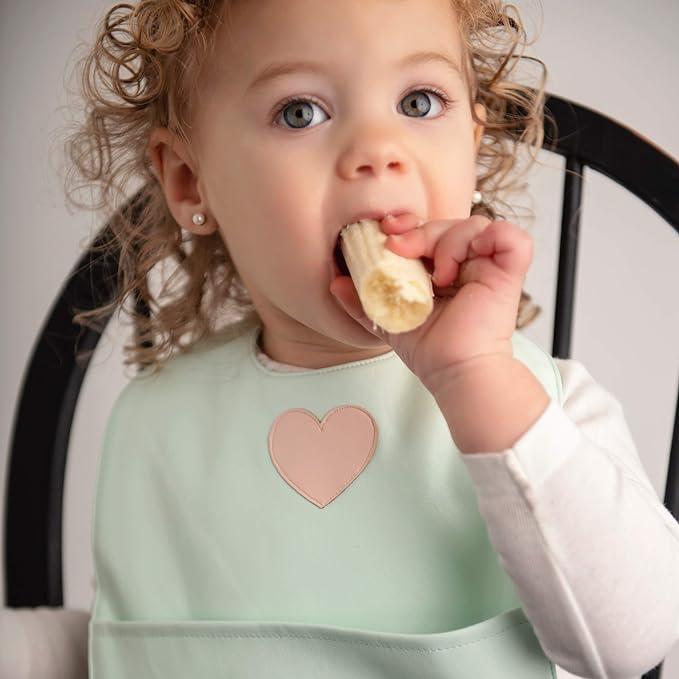 Set of premium vegan leather bibs for infants and toddlers, featuring adjustable snaps and a large pocket for easy cleaning.