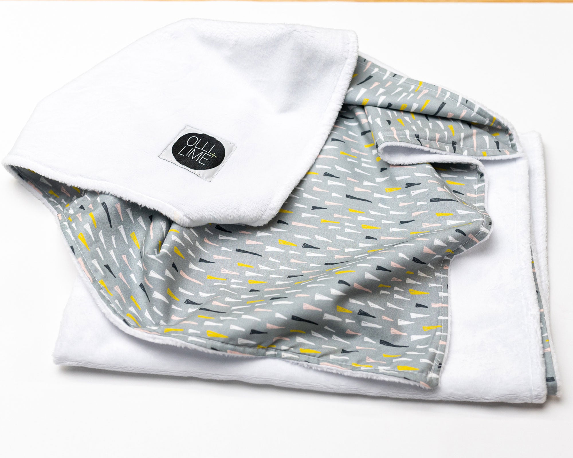 Jester's Hat Deluxe Crib Bedding Set featuring colorful jester hats on a sage background with a charcoal gray crib skirt.