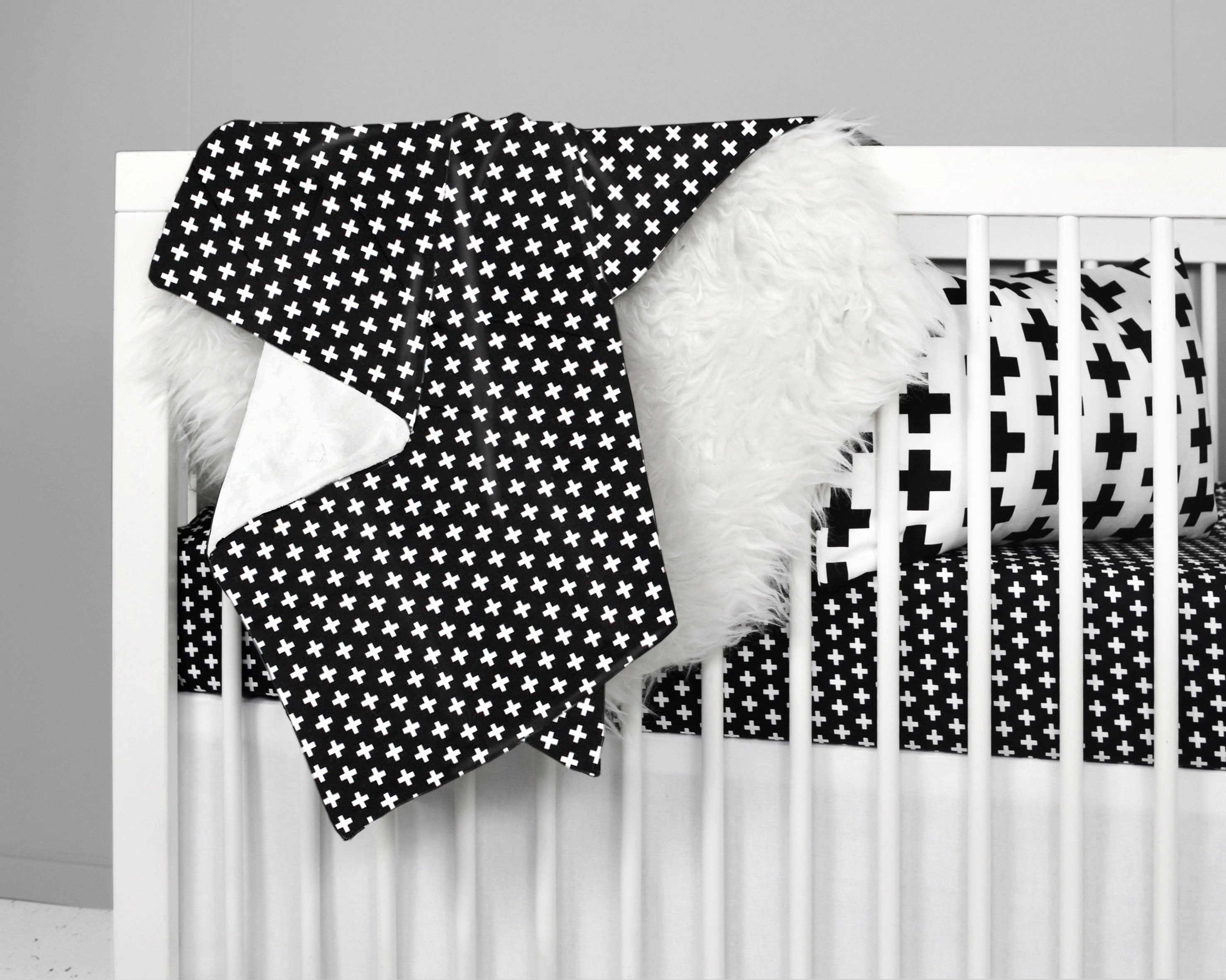 Lina Deluxe Crib Bedding Set featuring Swiss cross design in black and white with a grey weave blanket, perfect for modern nurseries.