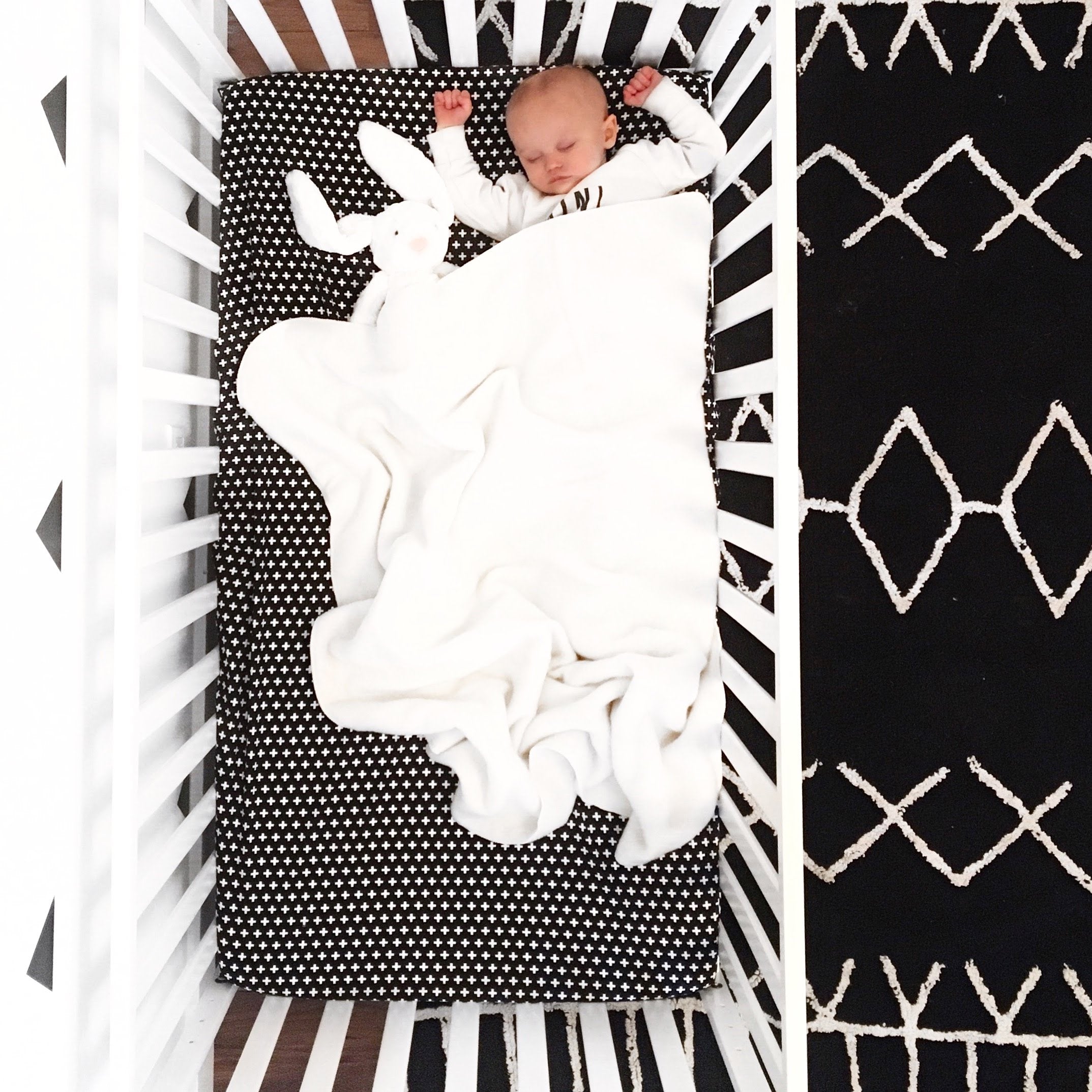Lina Deluxe Crib Bedding Set featuring Swiss cross design in black and white with a grey weave blanket, perfect for modern nurseries.