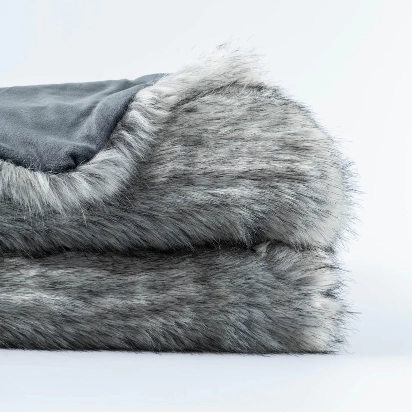 Slate Luxury Faux Fur Throw Blanket showcasing its plush texture and elegant grey color, perfect for home decor.