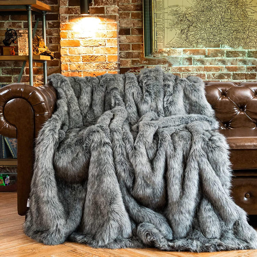 Slate Luxury Faux Fur Throw Blanket showcasing its plush texture and elegant grey color, perfect for home decor.