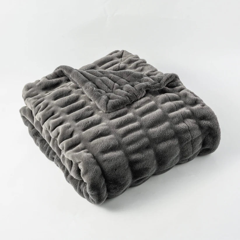 Reversible Rabbit Fur Blanket showcasing its elegant design and soft texture, perfect for home decor.