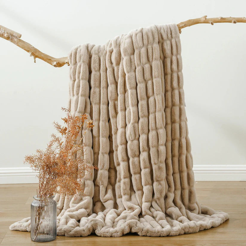 Reversible Rabbit Fur Blanket showcasing its elegant design and soft texture, perfect for home decor.