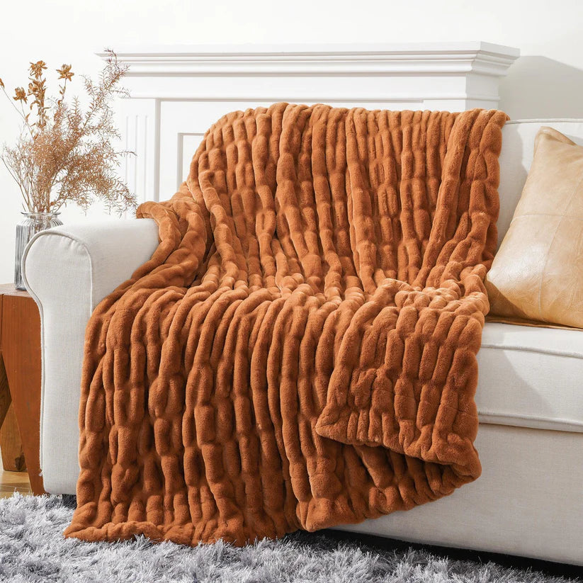 Reversible Rabbit Fur Blanket showcasing its elegant design and soft texture, perfect for home decor.