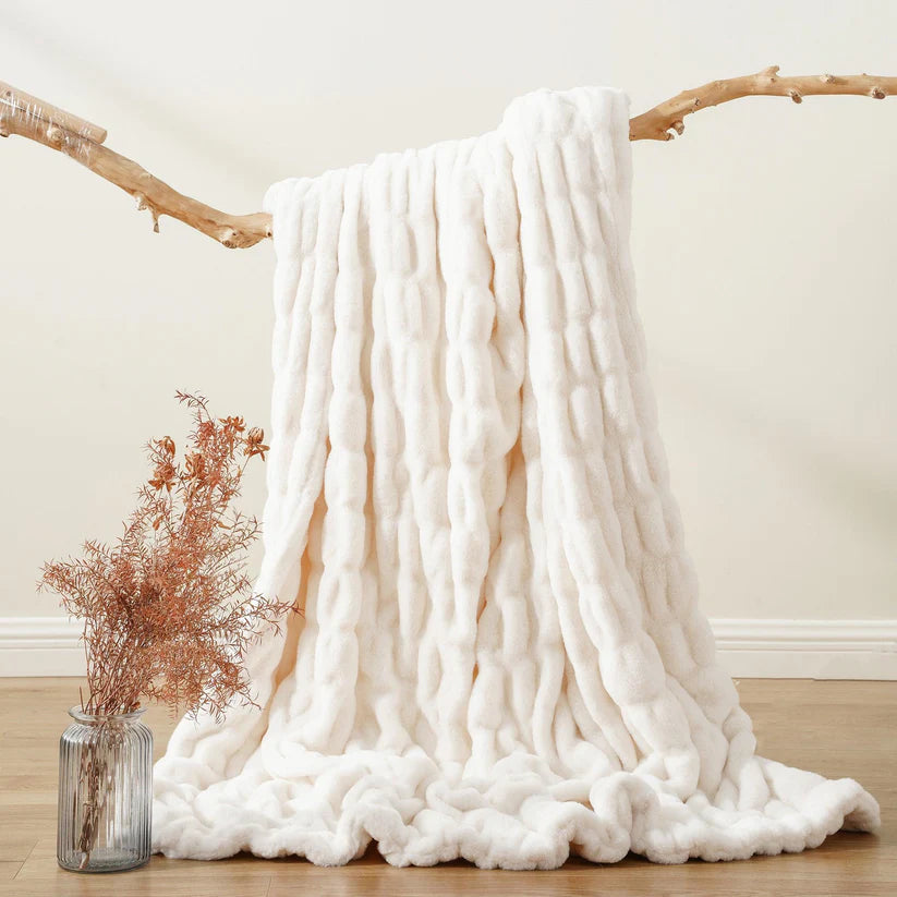 Reversible Rabbit Fur Blanket showcasing its elegant design and soft texture, perfect for home decor.