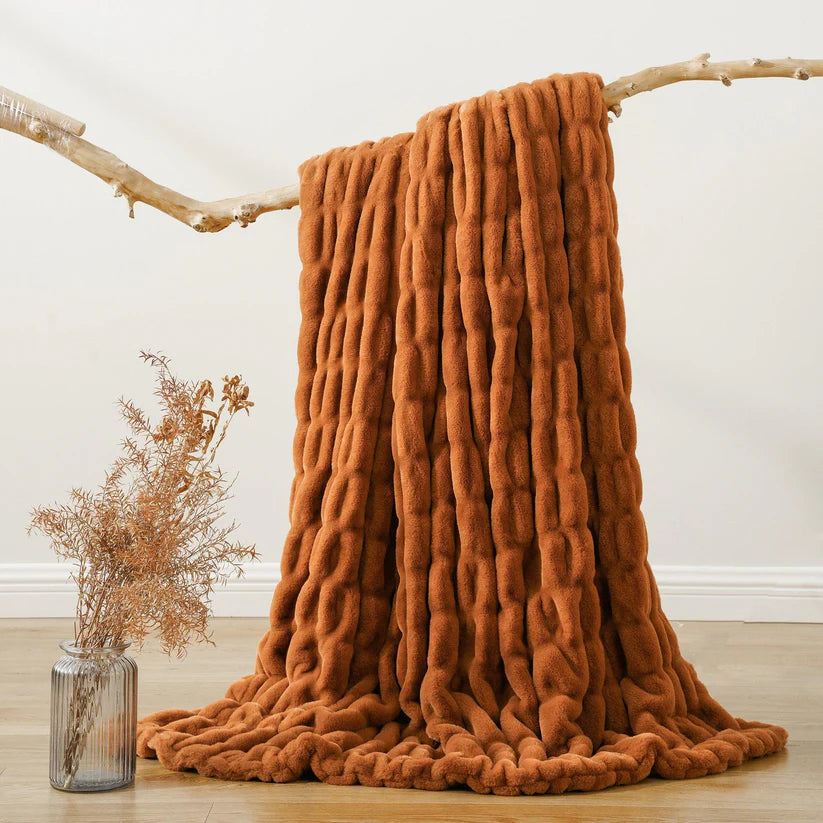 Reversible Rabbit Fur Blanket showcasing its elegant design and soft texture, perfect for home decor.