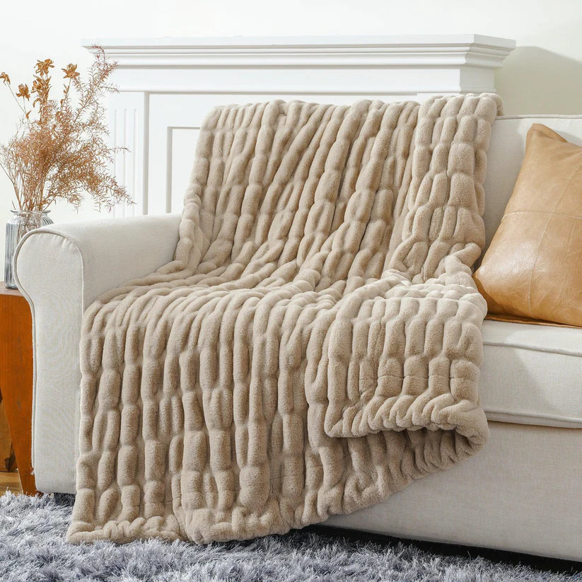 Reversible Rabbit Fur Blanket showcasing its elegant design and soft texture, perfect for home decor.
