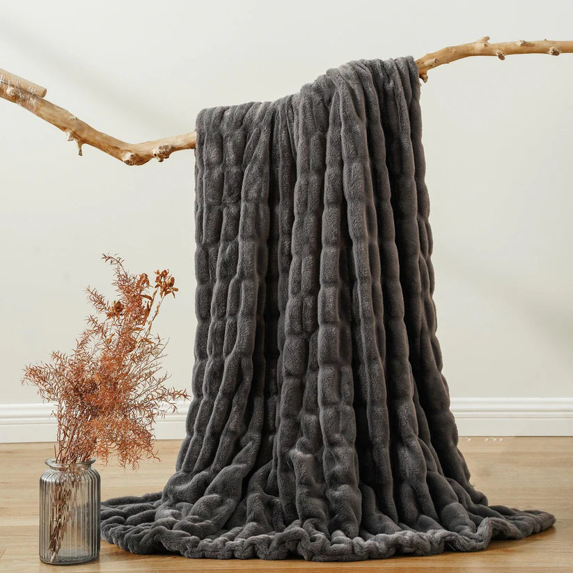Reversible Rabbit Fur Blanket showcasing its elegant design and soft texture, perfect for home decor.