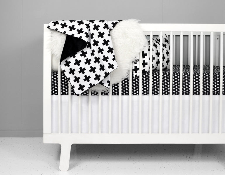 A crisp white crib skirt tailored for a standard crib, made from heavyweight cotton twill, enhancing nursery decor.