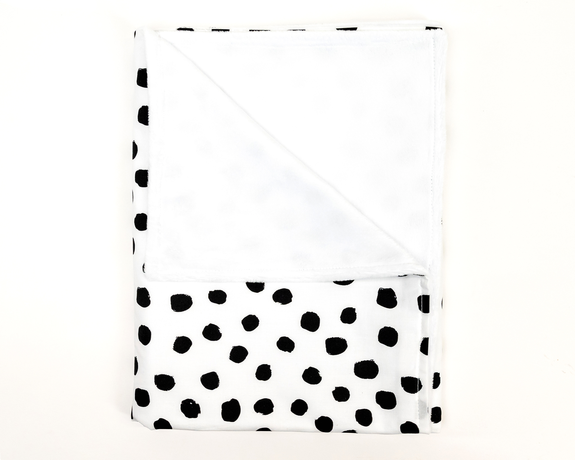 Zoe's Spots & Dots Baby Blanket featuring playful black dots on a white background, soft minky backing, and premium cotton fabric.