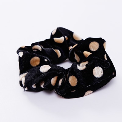 A stylish women's headwear made of soft coral fleece featuring a trendy leopard spot pattern, designed for comfort and a snug fit.