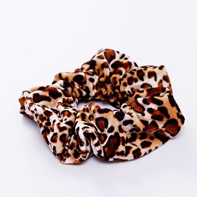 A stylish women's headwear made of soft coral fleece featuring a trendy leopard spot pattern, designed for comfort and a snug fit.