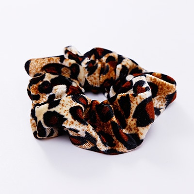 A stylish women's headwear made of soft coral fleece featuring a trendy leopard spot pattern, designed for comfort and a snug fit.