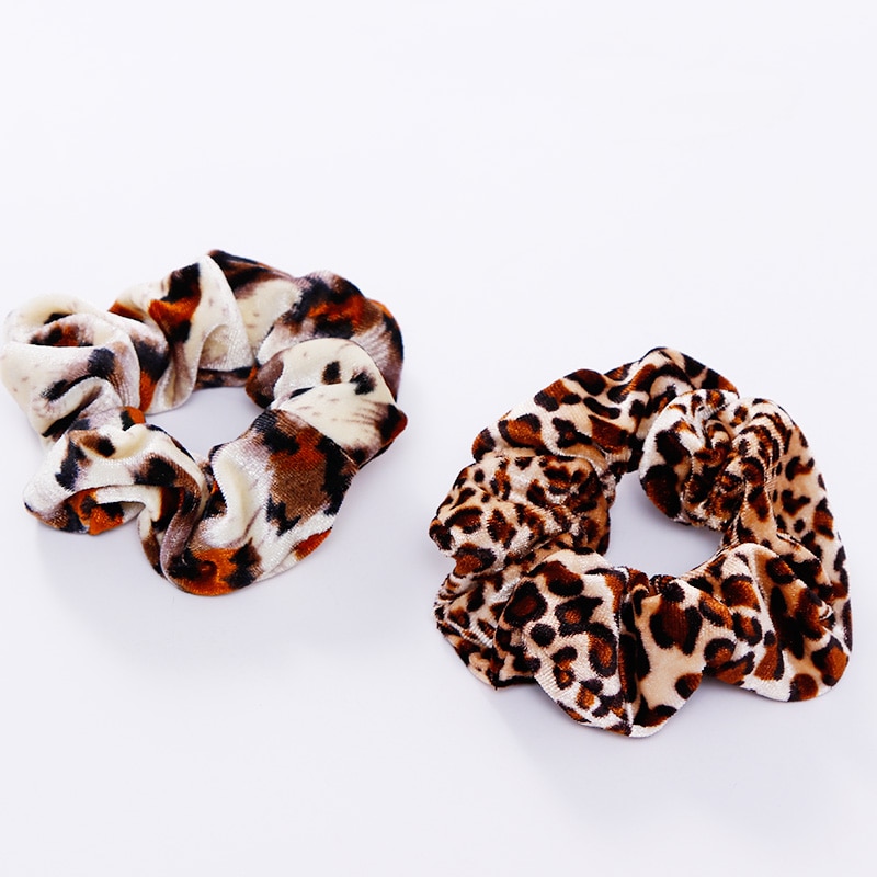 A stylish women's headwear made of soft coral fleece featuring a trendy leopard spot pattern, designed for comfort and a snug fit.