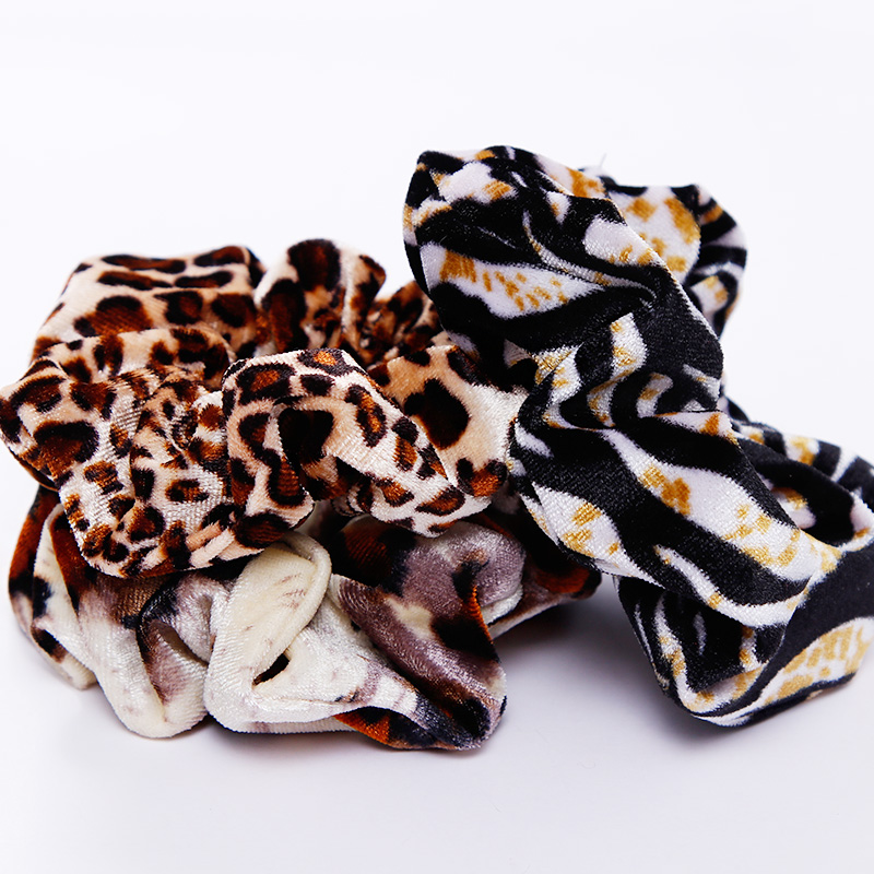 A stylish women's headwear made of soft coral fleece featuring a trendy leopard spot pattern, designed for comfort and a snug fit.