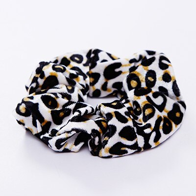 A stylish women's headwear made of soft coral fleece featuring a trendy leopard spot pattern, designed for comfort and a snug fit.