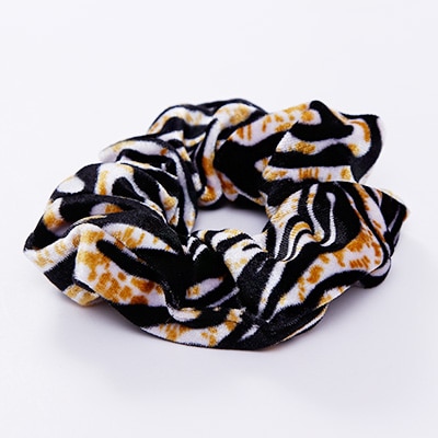 A stylish women's headwear made of soft coral fleece featuring a trendy leopard spot pattern, designed for comfort and a snug fit.