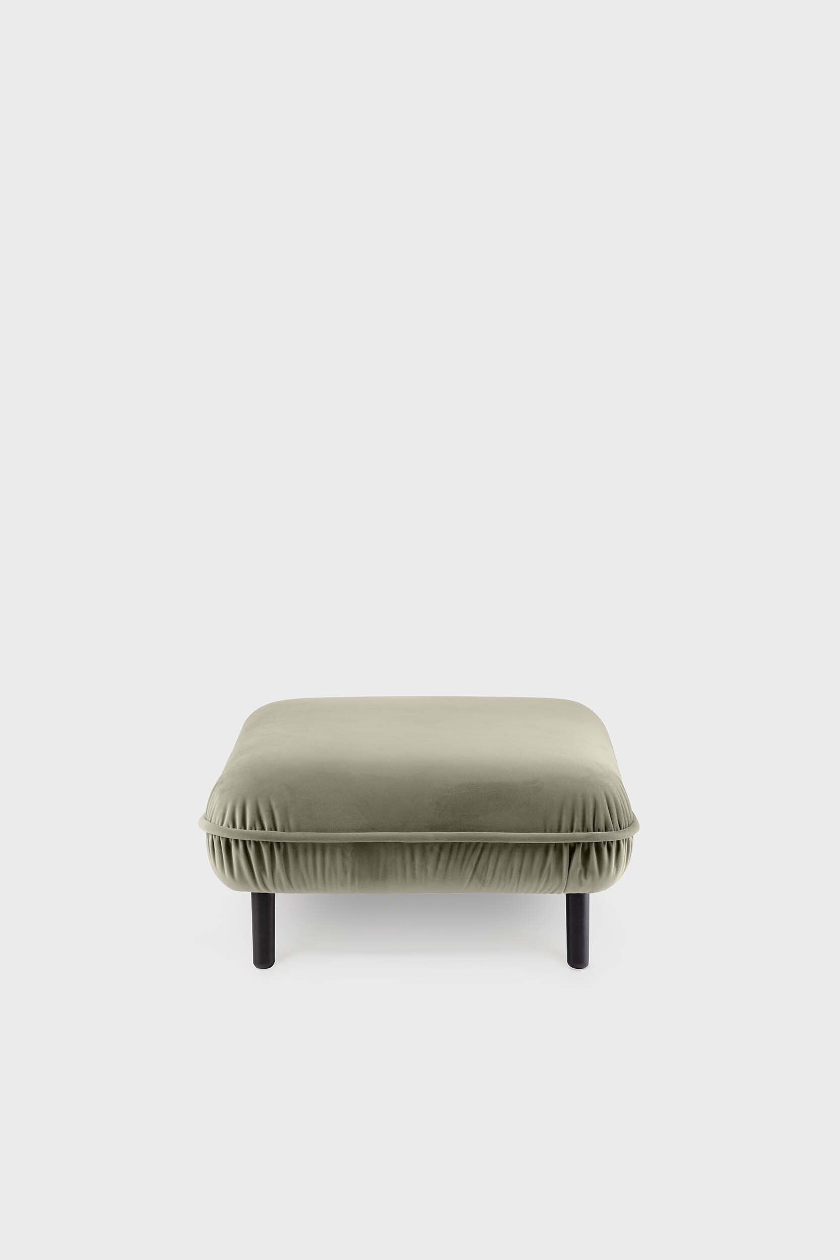 Bean Pouf featuring soft pleated velour fabric and elegant wooden legs, available in five colors.