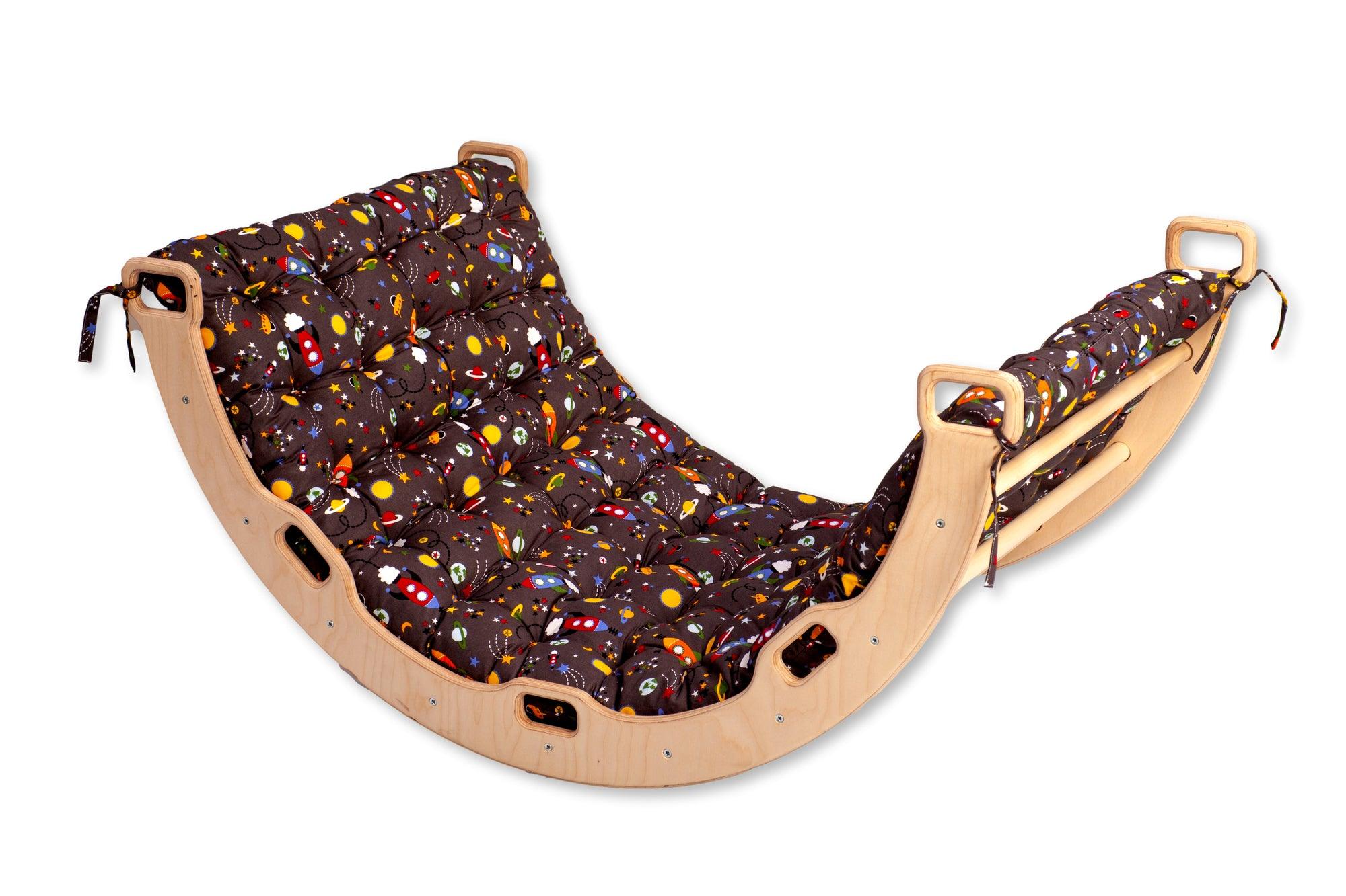A wooden climbing arch rocker board play set with a gray space design pillow, designed for children's active play and development.
