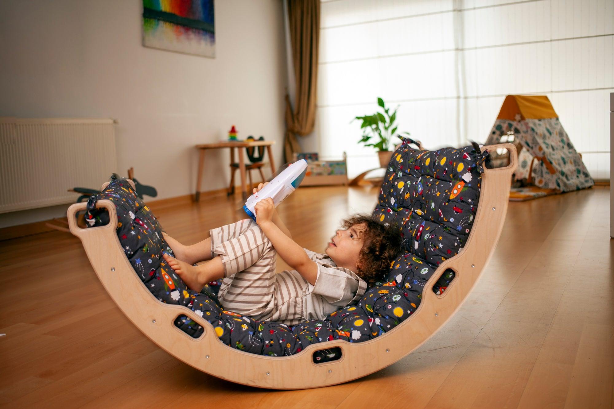 A wooden climbing arch rocker board play set with a gray space design pillow, designed for children's active play and development.