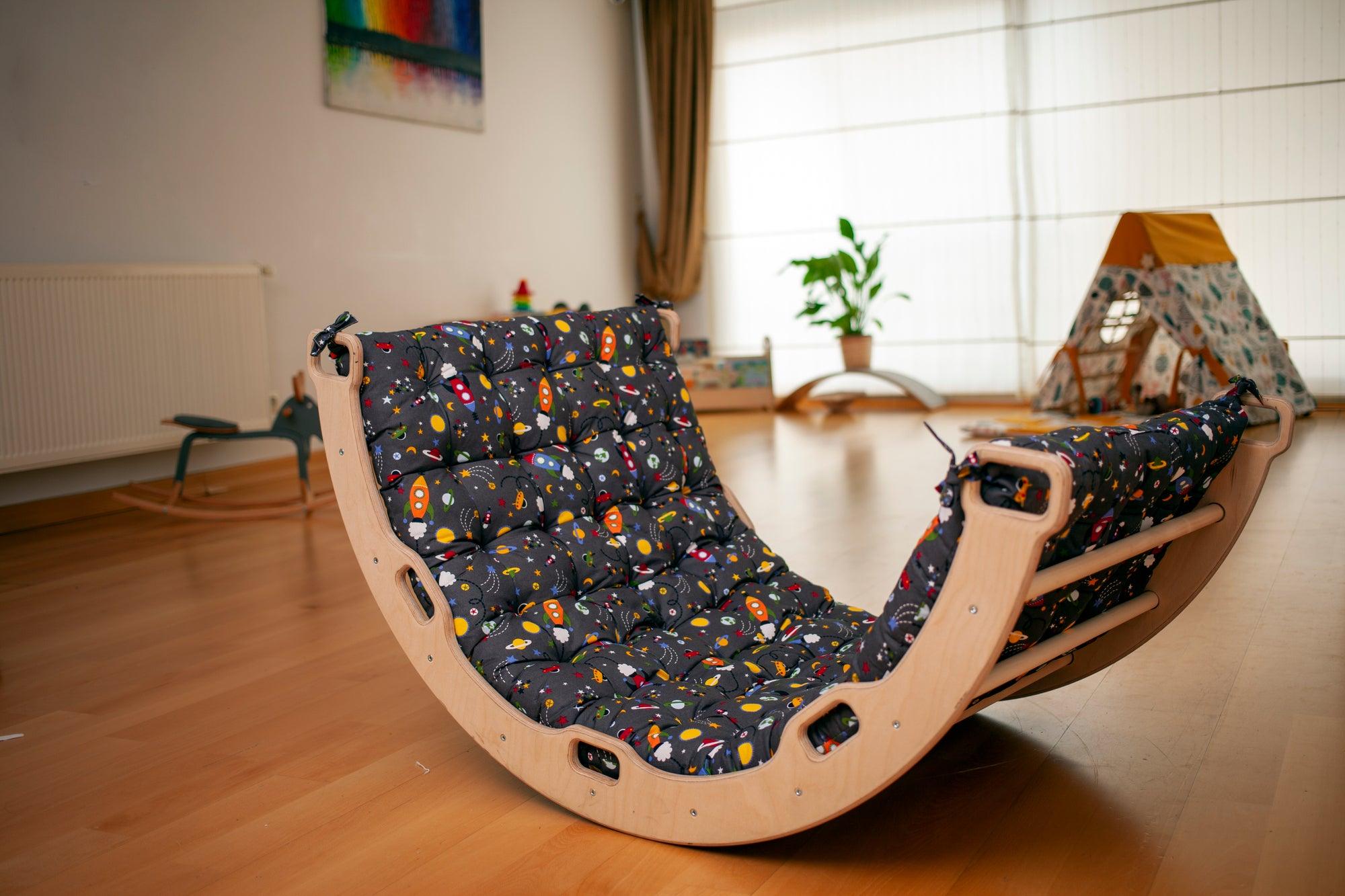 A wooden climbing arch rocker board play set with a gray space design pillow, designed for children's active play and development.