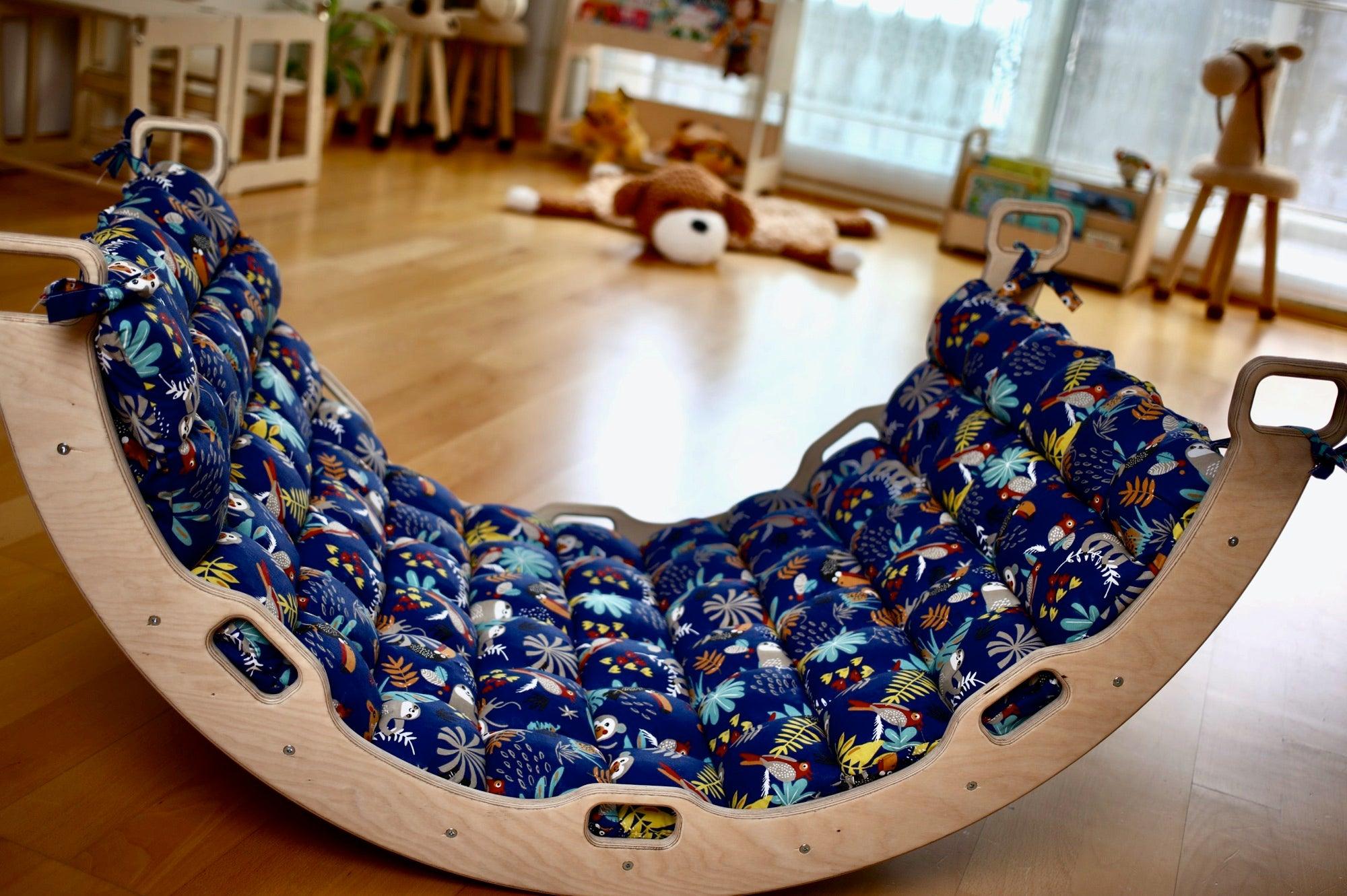 Montessori Arch Rocker with Ramp and Pillow, designed for children's active play, featuring a curved wooden structure and a soft pillow.