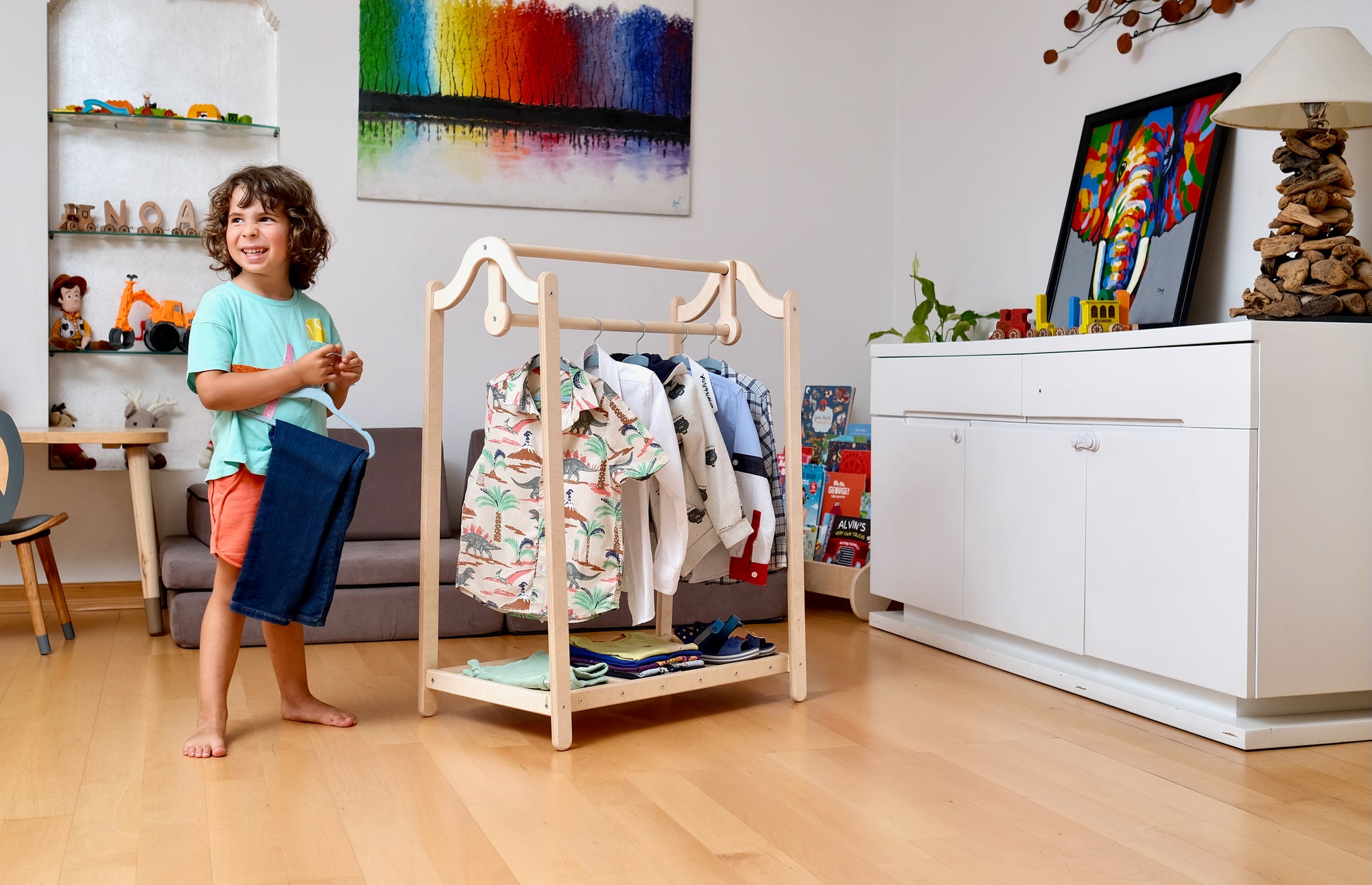 Montessori Wooden Kids Clothing Rack made of birch plywood, featuring adjustable hanging bars and an open shelf for easy access to children's clothing.